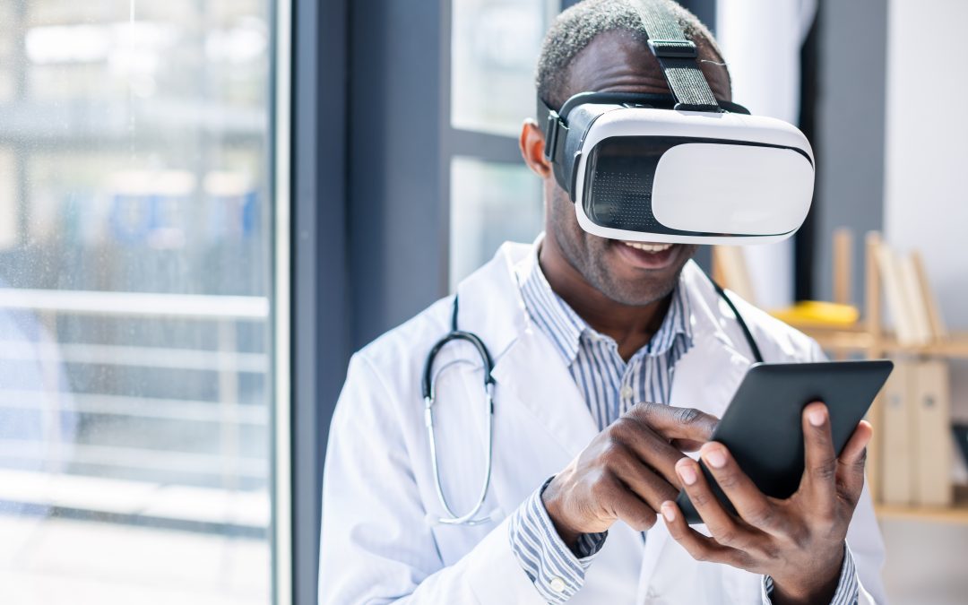 A doctor using a digital tablet with a set of virtual reality goggles